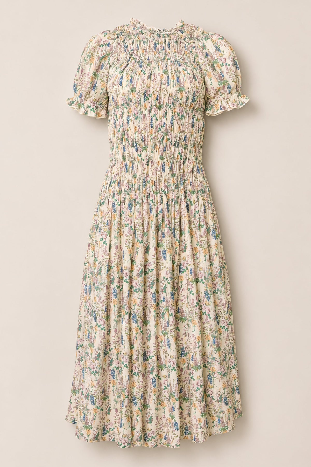 The Jennifer Dress in Autumn Bouquet by Ivy City Co is a floral midi dress featuring short puff sleeves, a smocked bodice, and a flowy skirt. Designed with a multicolored pastel flower print on a light background, this maternity-friendly dress combines style and comfort for any occasion.