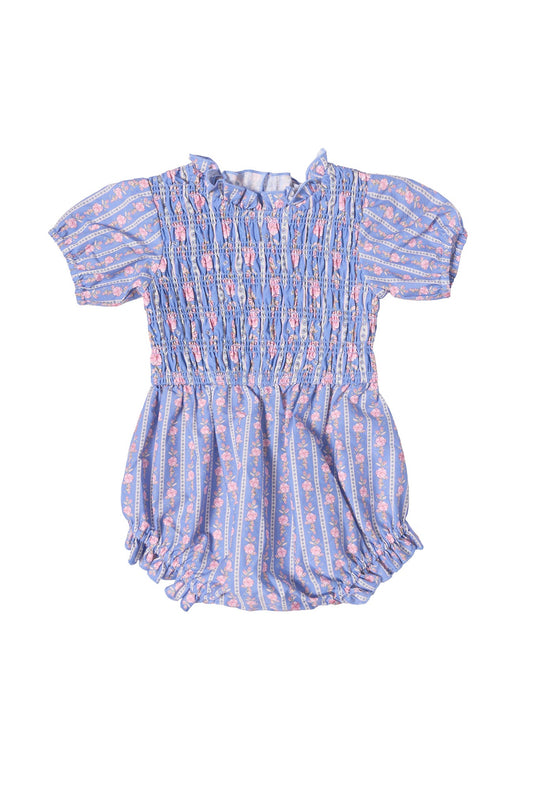 The Baby Mariah Romper in Linear Print by Ivy City Co is a short-sleeve romper featuring blue and pink linear floral stripes, a smocked bodice, ruffled collar, and elastic leg openings, shown on a white background.
