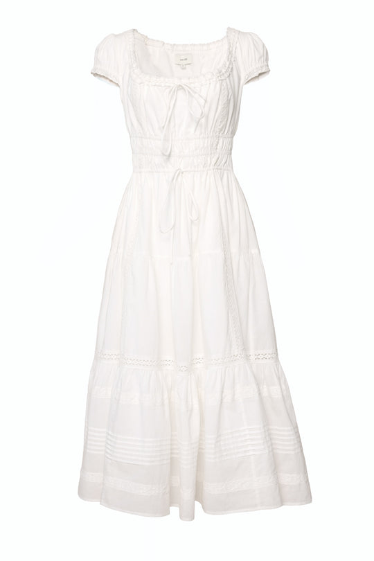 The Palermo Dress in White by Ivy City Co features short sleeves, ankle-length flowy tiers, a square neckline, fitted bodice, delicate lace accents, and a front tie—chic and comfortable for maternity wear.