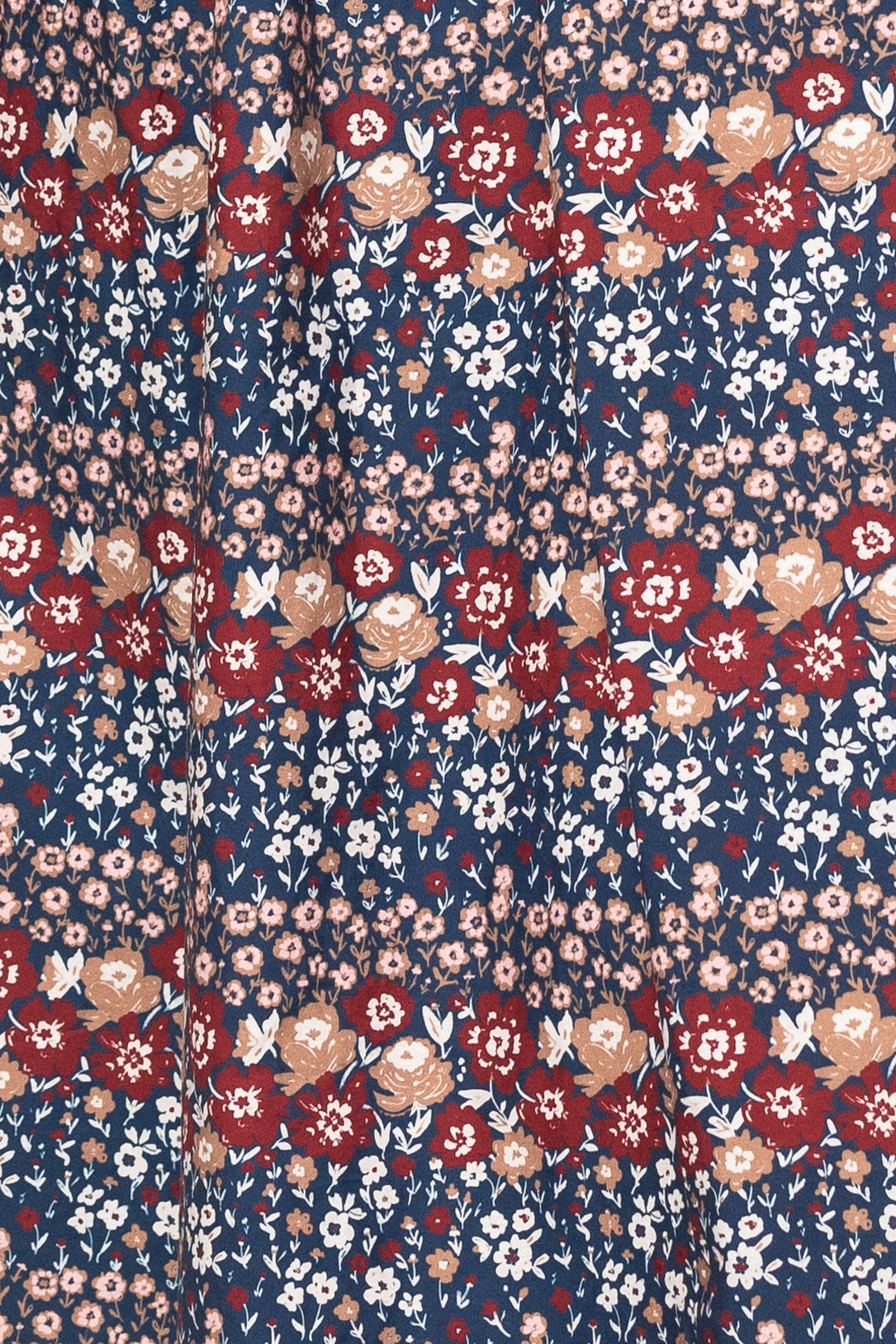 Floral patterned fabric with red, pink, and white flowers on a blue background