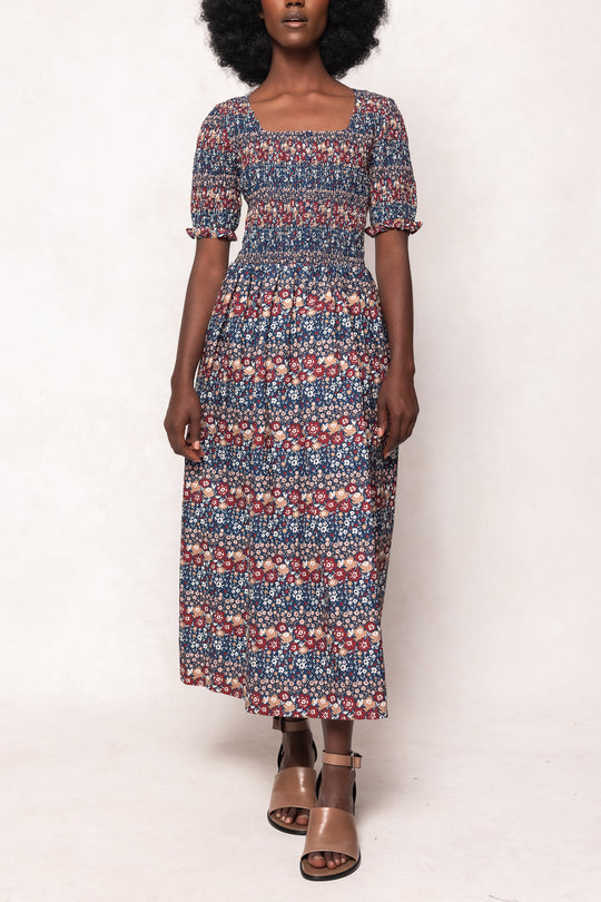 Woman wearing a patterned dress on a white background