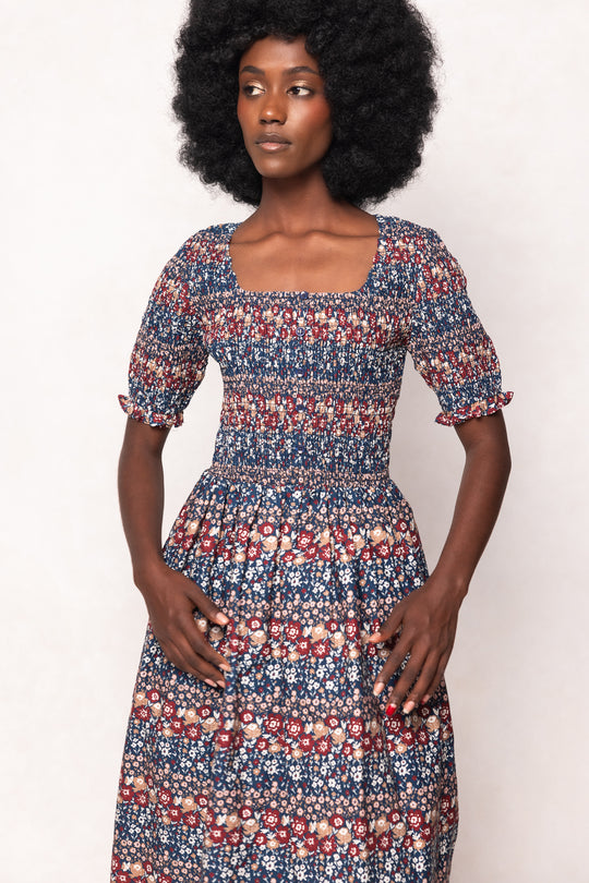 Woman wearing a floral dress with a white background