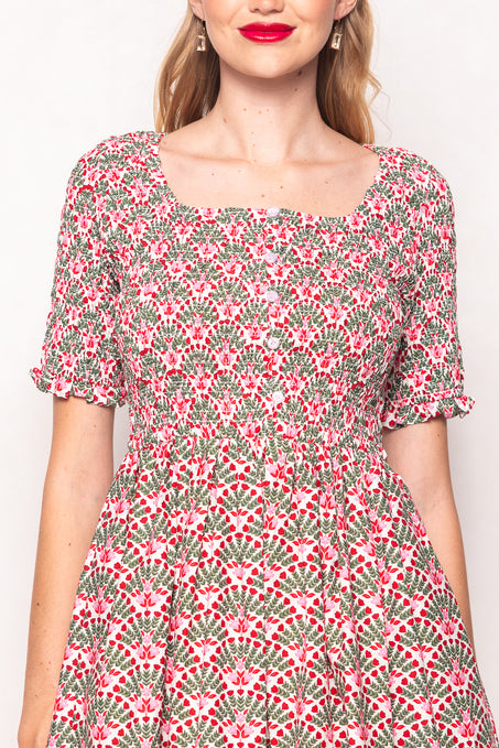 Woman wearing a floral dress with a plain background