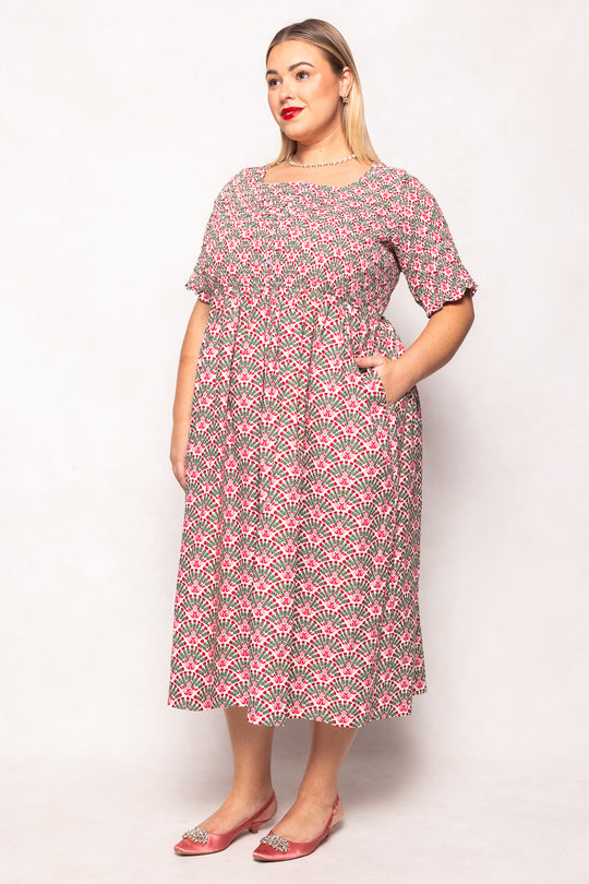 Woman wearing a floral dress against a white background