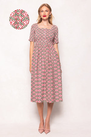 Woman wearing a floral dress with a small floral pattern on a white background