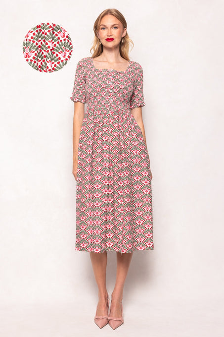 Woman wearing a floral dress with a small floral pattern on a white background