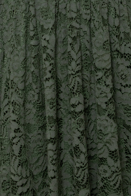 Close-up of green lace fabric with floral patterns