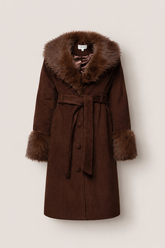 The Pookie Coat in Warm Cocoa by Ivy City Co is a brown suede coat featuring a wide faux fur collar and cuffs, a matching fabric belt at the waist, and button closure down the front, all displayed against a plain light background. Nursing friendly and stylish, this piece seamlessly blends comfort with chic design.