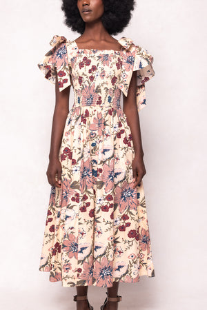 Woman wearing a floral dress against a white background