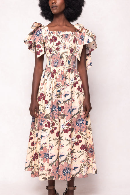 Woman wearing a floral dress against a white background
