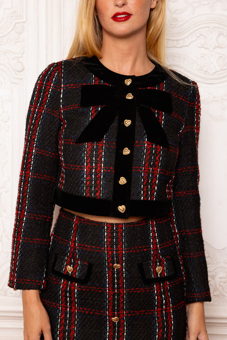 Black and red plaid outfit with a large bow and gold buttons on a white background