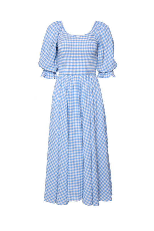 The Teagan Dress in Blue Gingham by Ivy City Co features a light blue and white gingham print, puffed short sleeves, a smocked bodice, and a flowy midi skirt—making this charming dress both maternity friendly and perfect for effortless, everyday style.