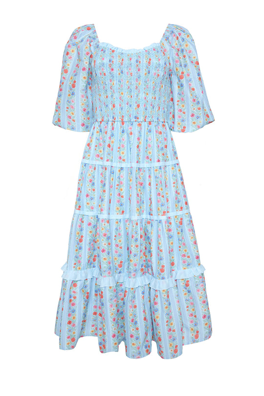 a blue floral dress against a white background