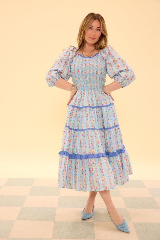 Woman wearing a floral dress on a checkered floor background