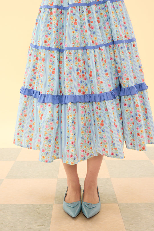 Skirt with floral pattern and ruffled layers on a plain background