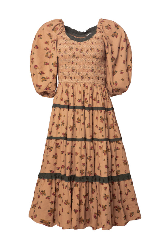 The Roselyn Dress in Desert Blossom by Ivy City Co is a vintage-style peach cotton midi with puffed sleeves, smocked bodice, floral print, and dark green trim on the tiered skirt and cuffs.
