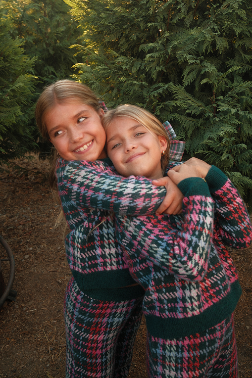 Madison and her daughter hugging beside the car door