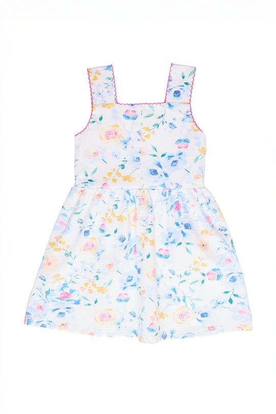 The back of a white floral dress against a white backdrop