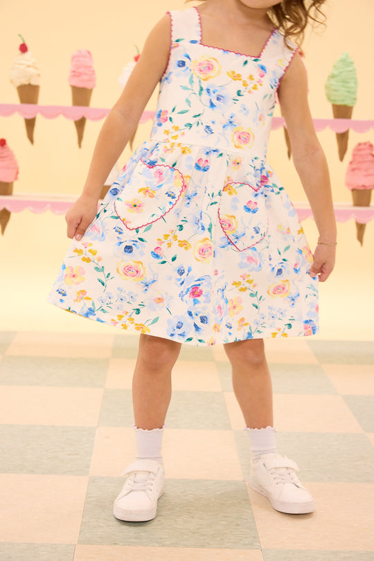 Child wearing a floral dress with ice cream cone background
