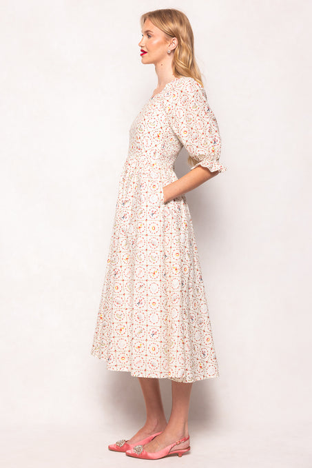 Woman wearing a floral dress against a white background
