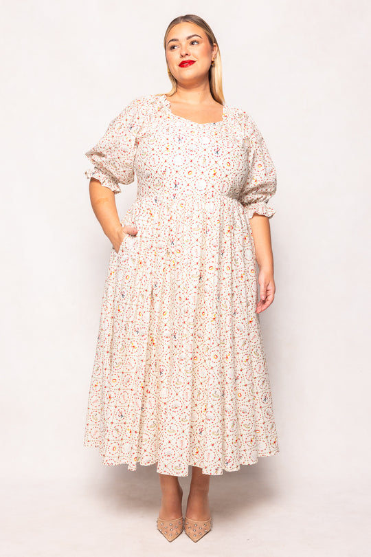 Woman wearing a floral dress against a white background