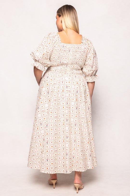 Woman wearing a floral dress against a white background