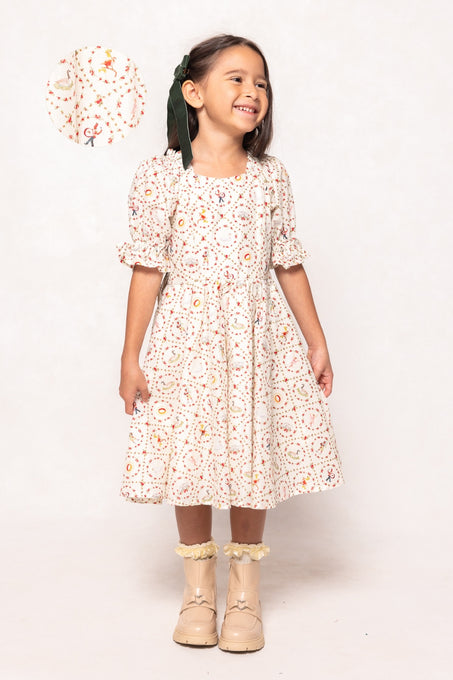 Young girl wearing a floral dress with a white background