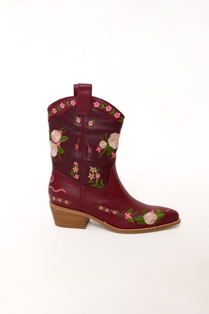 Red cowboy boot with floral embroidery on a white background