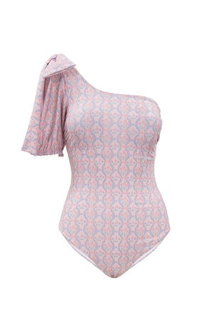 The Sailor One Piece in Raquel Pink Floral features an asymmetrical neckline, a left one-shoulder ruffled sleeve, and a fitted body with an intricate pastel floral pattern—perfect for a chic summer style.