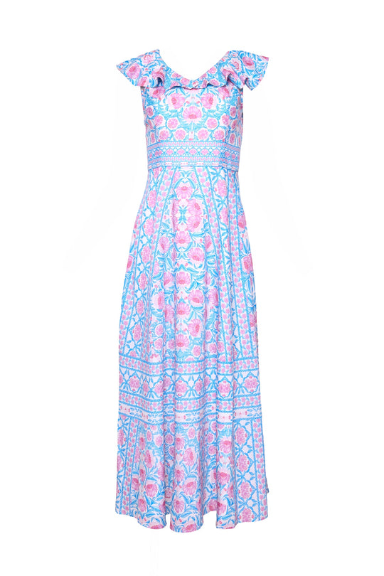 The Ivy City Co Samara Dress in Thistle Flower Mosaic Florise is a sleeveless, ankle-length dress with ruffled shoulders and a pink and blue floral pattern on a white background.