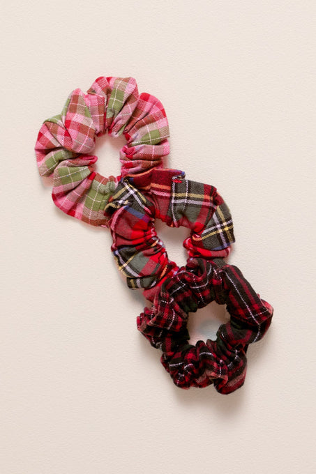 Set of plaid scrunchies on a beige background
