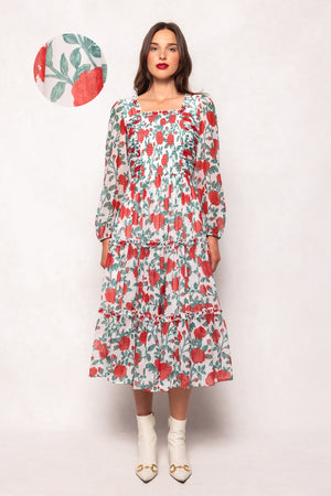 Woman wearing a floral dress with a plain background