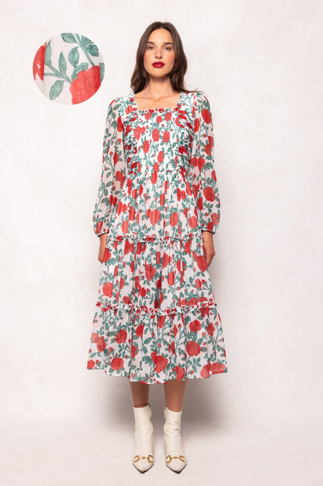 Woman wearing a floral dress with a plain background