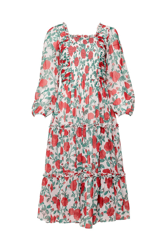 The Selena Dress in Red Roses by Ivy City Co is a long, flowy chiffon midi dress adorned with a red and green floral pattern inspired by classic red roses. It features puffed long sleeves, a smocked bodice, and a tiered skirt. This style is also maternity friendly for added comfort and versatility.