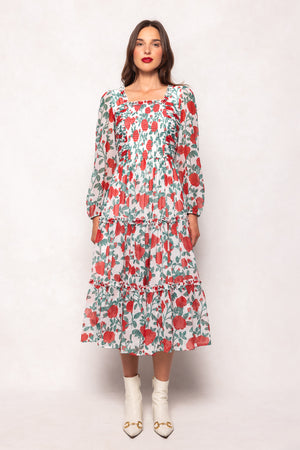Woman wearing a floral dress against a white background