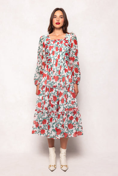 Woman wearing a floral dress against a white background