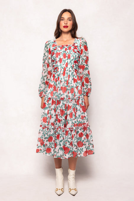 Woman wearing a floral dress against a white background