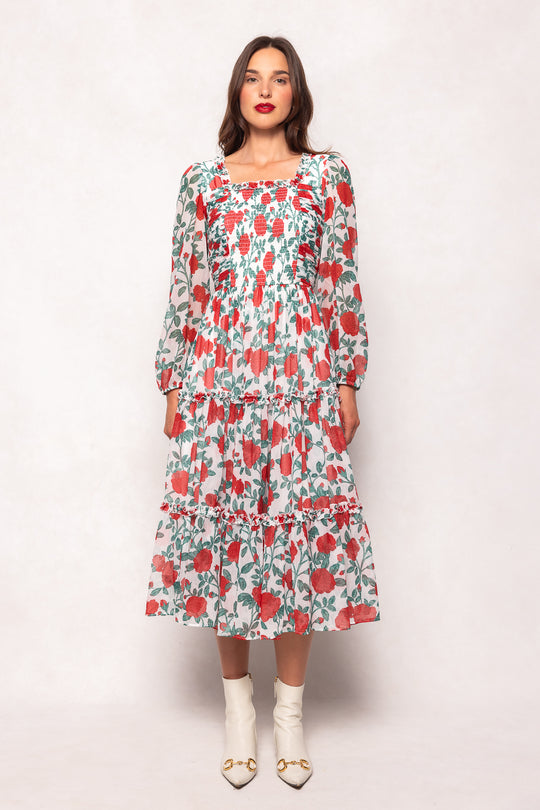 Woman wearing a floral dress against a white background