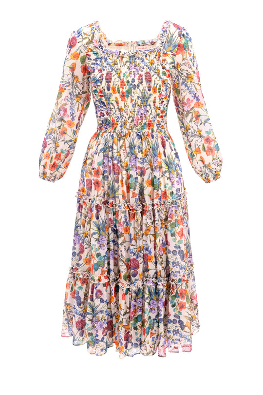 The Selena Dress in Vivid Meadow by Ivy City Co is a long-sleeve, ankle-length floral midi dress with a smocked bodice, ruffled neckline, tiered skirt, and lightweight semi-sheer fabric for a breezy look.
