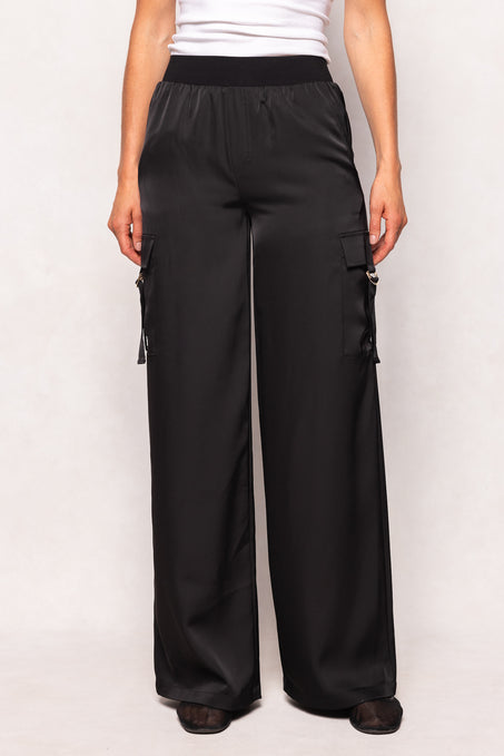 Black cargo pants worn by a person on a white background