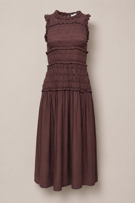 Sleeveless, knee-length Simone Dress in Warm Cocoa by Ivy City Co, featuring a smocked bodice, ruffled neckline and shoulders, and a gathered skirt—maternity friendly and displayed against a plain light background.