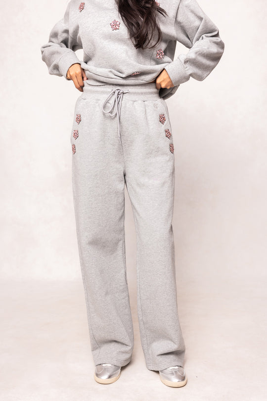 girl wearing gray pants against a white background