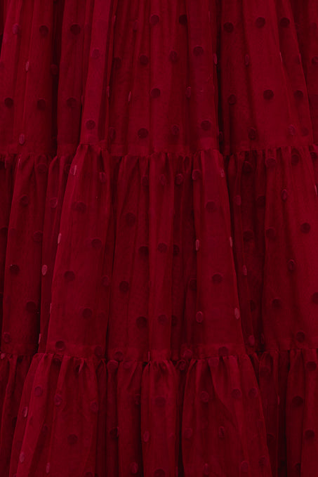 Close-up of a red dress with black polka dots