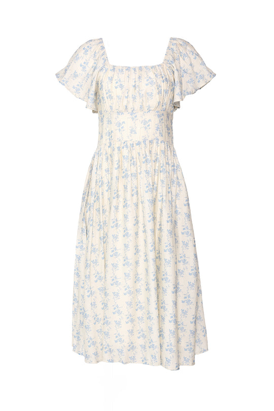 The Ivy City Co Sonoma Dress in Ivory Porcelain Fleur features a square neckline, gathered bodice, and flowy knee-length skirt with a light cream base and blue floral print—perfect for sunny days.