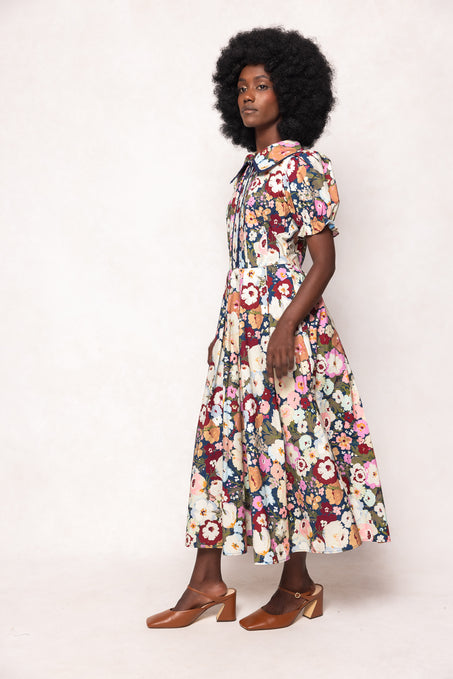 Woman wearing a floral dress against a white background