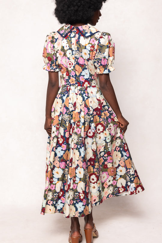 Woman wearing a floral dress against a white background