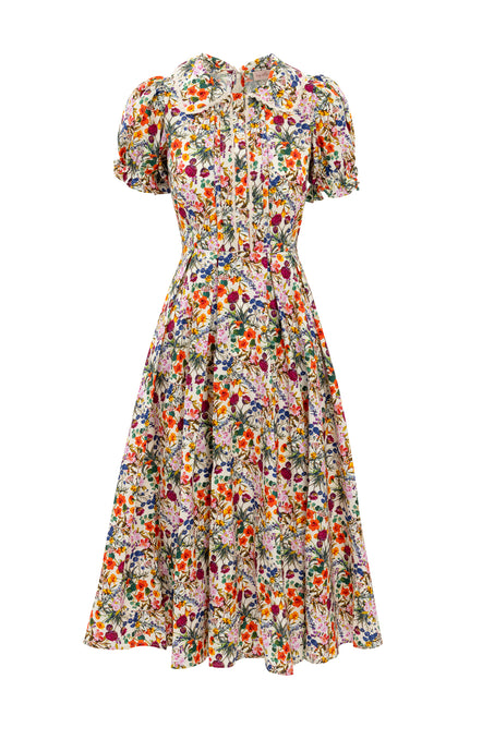The Sophia Dress in Multicolor Floral by Ivy City Co is a vintage-inspired cotton midi with short sleeves, ruffled collar, bow neck detail, fitted waist, and wide skirt—delicate and feminine for timeless charm.