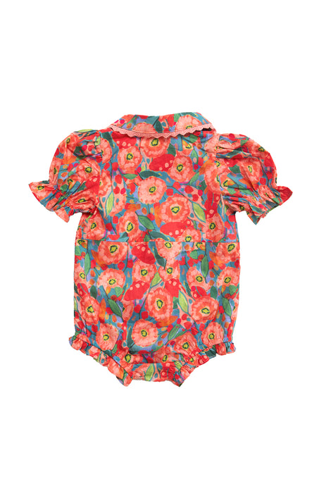 The Ivy City Co Baby Sophia Romper in Poppy is a colorful cotton romper featuring short puffed sleeves, a collar, bright red, pink, and green floral print, plus ruffled trim on the sleeves and leg openings for added charm.