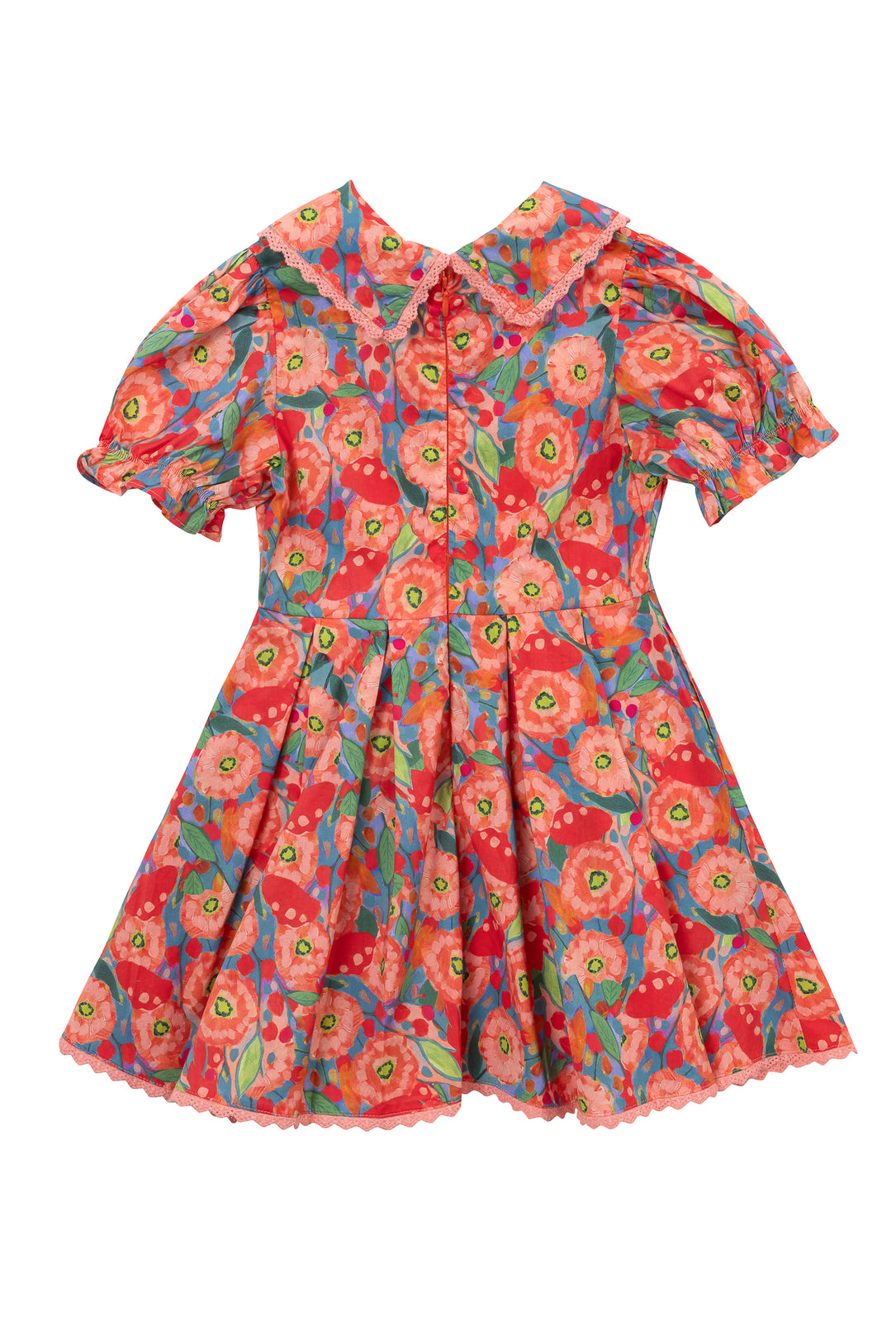 The Mini Sophia Dress in Poppy is a short-sleeved, knee-length cotton dress for girls with a floral pattern in red, pink, green, and blue. It features a Peter Pan collar, front buttons, puffed sleeves, and a pleated skirt.