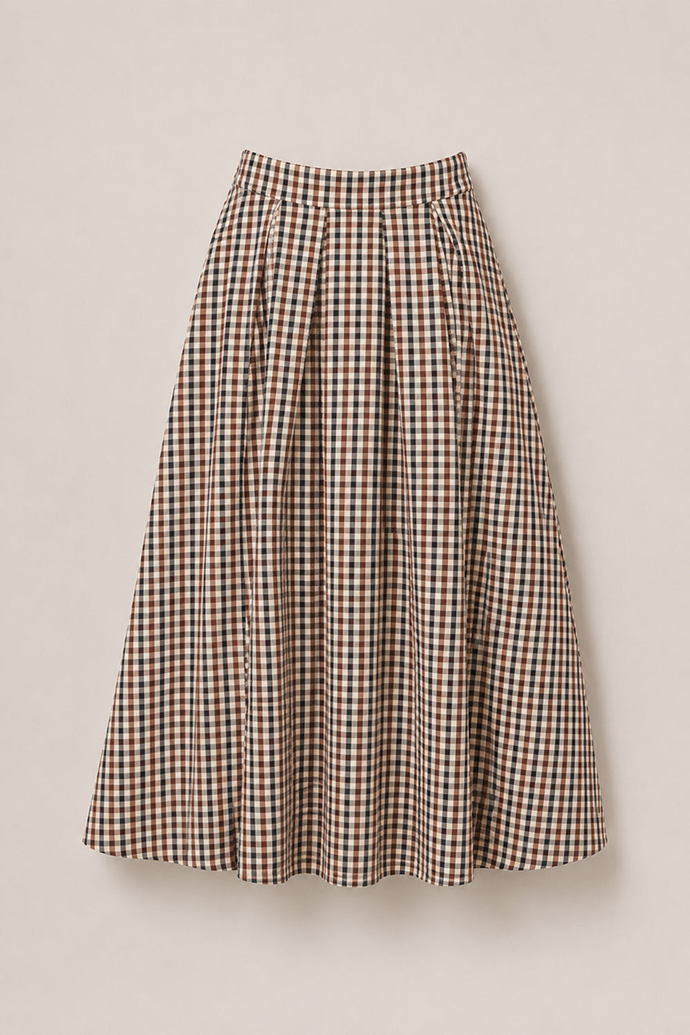 The Sophia Skirt in Chestnut Gingham by Ivy City Co is a mid-length, high-waisted skirt with a flared silhouette, featuring a checkered gingham pattern in shades of brown, beige, and black. Crafted from soft cotton fabric, this stylish skirt is showcased against a light background.